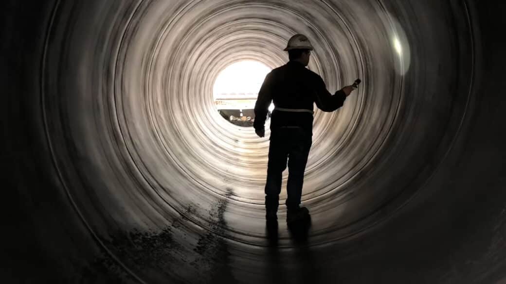 Visual inspection of engineered steel pipe interior welds.